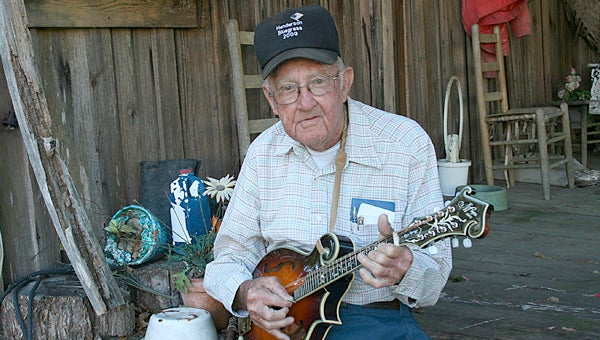 Rex Locklar joked that he couldn't keep the fans away from his annual bluegrass festival at Henderson. The event draws hundreds of musicians and fans each fall to the sleepy town of Henderson. This year, they will come to honor him. (File Photo/Jaine Treadwell)
