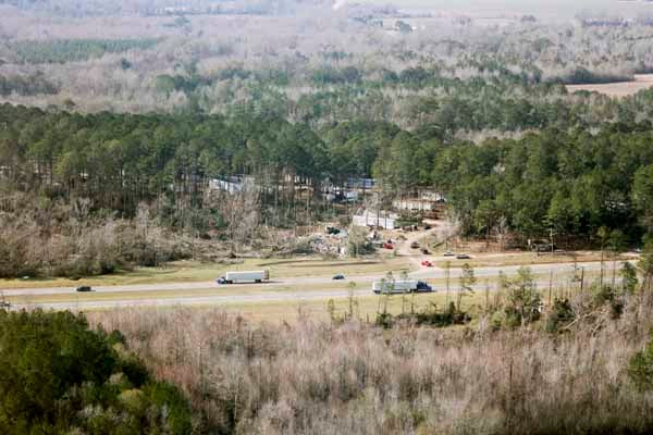Snapped trees and destroyed mobile homes dot the landscape at Brantley Mobile Home Park.