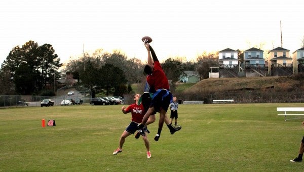 Photo/Ryan McCollough Players jump for a ball during 4-on-4 Flag Football Playoffs at Troy University.