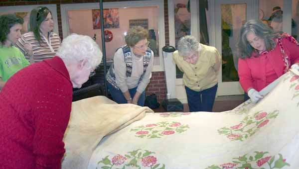 Sherry Burkhalter, right, discussed the detailed quilting patterns on a quilt from around 1850.  Burkhalter presented a Quilt Turning at the Pioneer Museum of Alabama on Saturday. 