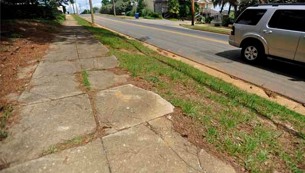 Sidewalks along Elm Street are cracked and shifted, which could be a safety hazard. 