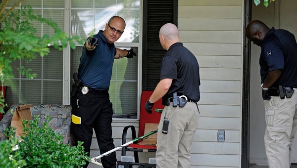 Police investigate the scene of a shooting on Woodland Hills Drive in Troy, Ala., Monday, July 8, 2013.  Police say that one person was killed and another injured in the shooting. Tiffany R. Upshaw, 24, of Troy, has been charged with murder in the incident. (Photo/Thomas Graning)