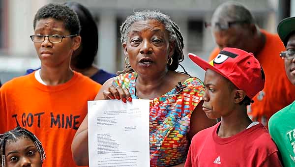 Dejerilyn King Henderson, center, discusses a lawsuit during a news conference on Tuesday. Henderson, a city council member, is one the backers of a lawsuit filed against the Troy City Schools system regarding allegations of racial discrimination.