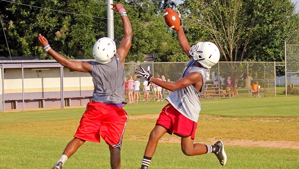 Goshen receiver Azontae Rogers (right) hauls in a catch over the outstretched arms of defensive back Deangelo Orum. (Photo/Ryan McCollough)