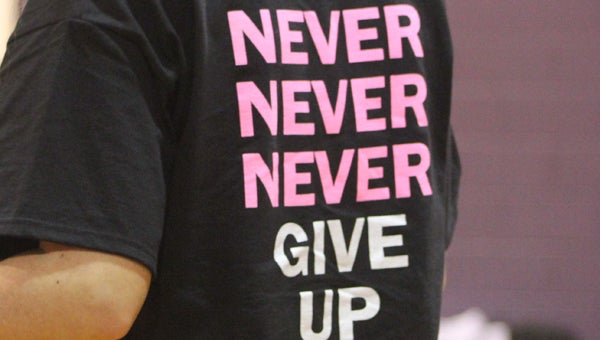 A linesman at the Goshen-Ariton match implores victims to never give up in the fight against breast cancer. 