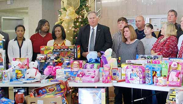 The people of Pike County donated $5,000 to Operation Toy Drop, which is sponsored by the statewide toy donation drive to benefit Children’s of Alabama. Operation Toy Drop is sponsored by sheriffs’ departments across the state. Joining Pike County Sheriff Russell Thomas at the Pike County Courthouse Thursday to celebrate the success of the toy drive were representatives from Troy Wal-Mart, Troy University Student Affairs, Troy University SGA, Troy University Ms. Elite Society, Lydia Sunday School Class of First Baptist Church, Troy Exchange Club, State Rep. Alan Boothe, Army Aviation Federal Credit Union and the Pike County Sheriff’s Department. (Photo by Jaine Treadwell)