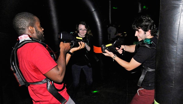 Troy University students Jordan Adams, left to right, Ashely May and Sino Tohirzoda play laser tag at Sartain Hall in Troy, Ala., Wednesday, Jan. 8, 2014.  (Photo/Thomas Graning)