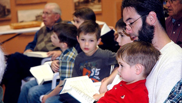 Kevin Eddins and his sons Ezra and Eli joined in the Sacred Harp Sing at the Pioneer Museum on Saturday.