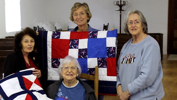 Members of the Elizabeth Bashinsky Chapter of the United Daughters of the Confederacy in Troy made quilts for five surviving Navajo code talkers who served their country during World War II. Seated, Virginia Richburg. Standing from left, Carol Glayre, Rita Moore and Dianne Brown, chapter president.