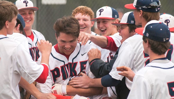 Blake Cumbie gets congratulated by his teammates after knocking in a grand slam home run in the fouth inning of Pike’s blowout win over Ashford Academy on Saturday. (Photo/Joey Meredith)