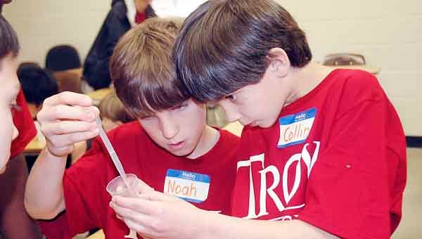 Noah Prestwood, left, and Collin King used measuring cups to demonstrate the availability of fresh, surface and groundwater. The Troy Elementary School fourth graders were among 500 students who participated in the Pike County Ground Water Festival at Troy University Wednesday.