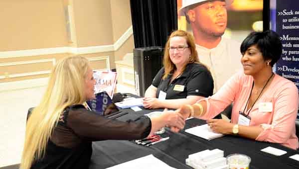 From left, Stephanie Power meets with Jennifer Grimes and Tracie Ridley, representatives of Alabama Power, about opportunities available to a construction company. Messenger photo/Mona Moore