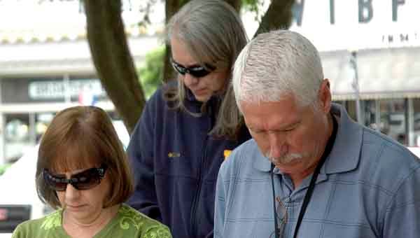 Participants bowed their heads in prayer Thursday as PIke County residents gathered to mark the National Day of Prayer. Local events included a prayer service on the Square in downtown Troy.