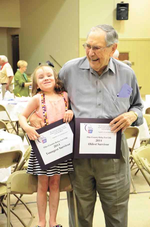 Lily Ann Barnett, 5, and Robert Newman, 91, the youngest and oldest survivors in attendance at Thursday’s survivors’ dinner, have a laugh together.