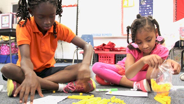 Troy Elementary students are enjoying summer learning fun at the school’s Summer Academy program, which began on Monday and will conclude this Friday. The program focuses on maintaining and improving reading and math skills between school years. Above, Sheridan Simms and Isabella Daniel work with math manipulatives.  (Messenger Photo/ April Garon)