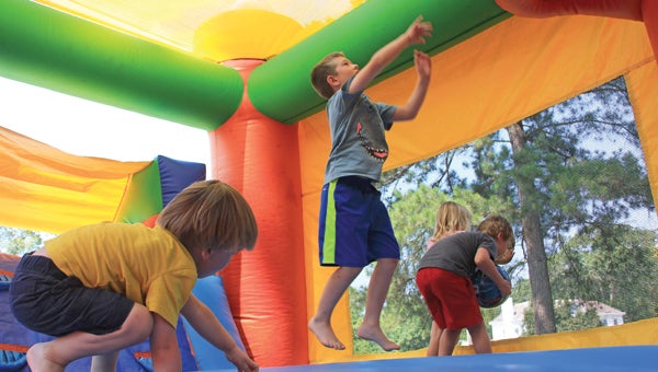 St. Mark Episcopal Church is hosting their vacation bible school this week, Wednesday through Friday. The theme this year is "Workshop of Wonders".  David Dawson, Evan Dye,  Josephine Dawson, and Camden Moseley bounce around in a moon jump on Thursday. (April Garon / Messenger Photo)