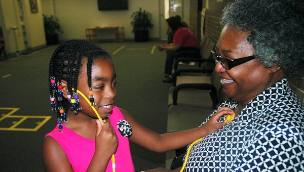 The children who participated in the Reach Out and Read event at Charles Henderson Child Health Center Wednesday had an opportunity to play doctor with a real stethoscope. Arianna Straw’s grandmother, Rita Boyd, was a willing patient. Arianna was amazed at the sound her grandmother’s heart made.