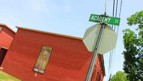 A banner hangs on the former Academy Street High School. The building is a state landmark. MESSENGER PHOTO/April G aron 