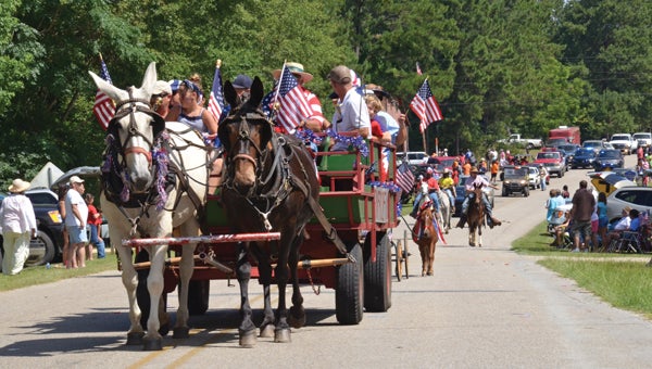 Participants in the Meeksville Independence Day Parade rode a wide variety of vehicles during the popular event Friday morning. Everything from horses, miniature horses, floats, and bicycles were included in the parade, which drew hundreds that gathered to celebrate. (Messenger Photo / April Garon)