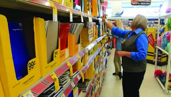 Troy Walgreens store manager Daphne Lee and associate Melanie Marusich straighten back to school supplies Thursday in preparation for the sales tax holiday that begins on Friday. Back to school items including clothing, books and computers are included in the tax holiday. MESSENGER PHOTO | APRIL GARON