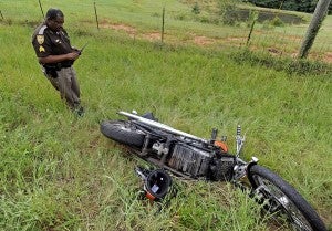 Pike County Sheriffs Office Sgt. Sam Mallory looks over the scene of a motorcycle wreck on U.S. Highway 29 North in Banks, Ala., Tuesday, Aug. 5, 2014. The driver was transported to a local hospital with unknown injuries. (Photo/Thomas Graning)