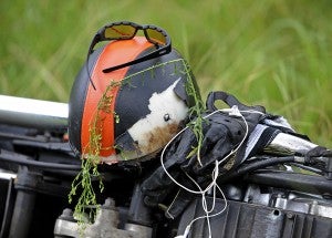 A helmet and other gear is seen as officers investigate the scene of a motorcycle wreck on U.S. Highway 29 North in Banks, Ala., Tuesday, Aug. 5, 2014. The driver was transported to a local hospital with unknown injuries. (Photo/Thomas Graning)