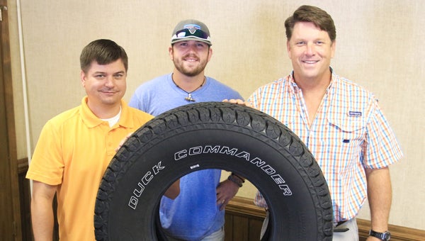 Ken Harris Jr. (right) and sales team  present the new line of Duck Commander Tires, which will be available in October. (Messenger Photo/ April Garon)