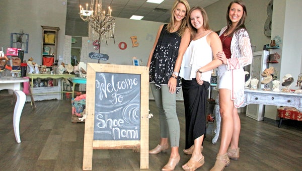 Messenger photo/ april Garon Shoe Nami is a new business in Troy which had its grand opening three weeks ago. Leann Boudin, Troy native, opened the business in the hopes of giving locals more variety in their shopping experience. Above, Cortnee Driggers, manager; and Kinsley Poole and Meghan Lanzi, sales associates, pose for a portrait at the Elba Highway storefront, which is decorated with local products. 