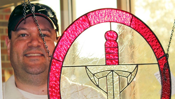 David Adams began crafting stained glass spirit items for Troy University, Auburn and Alabama earlier this year, after earning license agreements from the schools. His art is drawing high praise from local fans seeking unique, handcrafted items. (Messenger Photo / Jaine Treadwell)