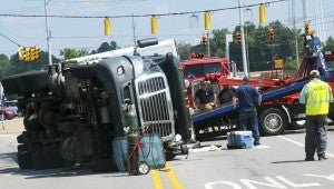 An 18-wheeler turned over at the intersection of Elba Highway and U.S. 231 Wednesday, backing up traffic for several hours.  Photo/David Smith