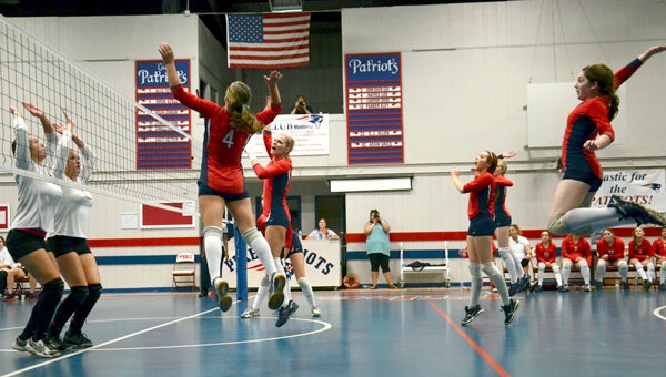 The PLAS volleyball team jumps with No. 4, Callee Jinright as she stretches to return a Colt ball. Below inset, Mya Terry readies to serve the ball to the Colts during their area match-up Tuesday night MESSENGER PHOTO/SCOTTIE BROWN