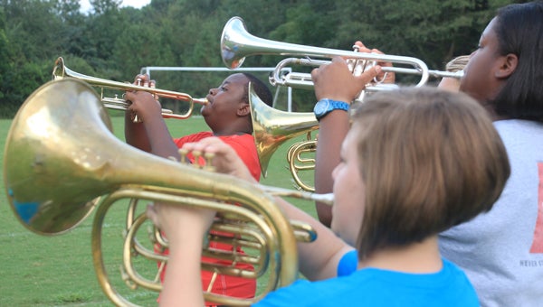 Arman Sheffield plays his trumpet with other brass players during Charles Henderson High School’s marching band practice Thursday evening.  MESSENGER PHOTO/APRIL GARON