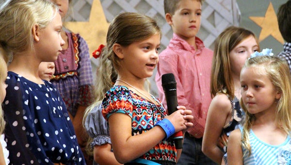 Above, Anna Kate Hardin recites a favorite memory she has of spending time with her grandparents during a presentation at Pike Liberal Arts School’s Grandparents’ Day. Kindergarten and elementary school students took to the stage and recited poems and memories while their grandparents watched in the audience. (MESSENGER PHOTOS / APRIL GARON)