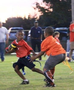 Rec League flag football teams the Bengals and the Texans squared off Thursday night along with other area teams. The Texans won 32-28. Above, Taquary Kelley runs the ball.  MESSENGER PHOTO/APRIL GARON