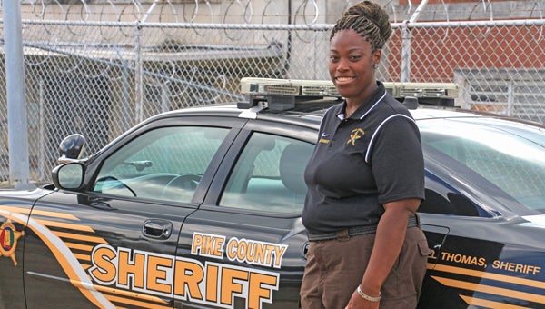 Andrea Degenett with stands with one of the Sheriff Department patrol cars. Thursday was her last day working with the Sheriff’s Department after seven years. Degenett will be moving to Birmingham to work with the Social Security Administration.  MESSENGER PHOTO/APRIL GARON