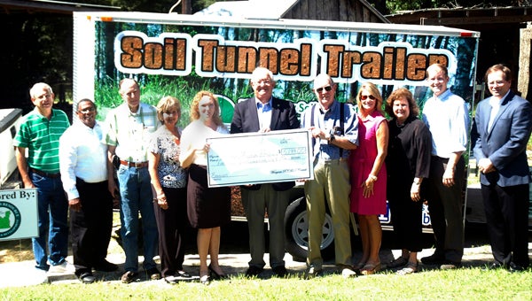 The Pike County Soil and Water Conservation District unveiled the soil tunnel trailer at the Pioneer Museum of Alabama. The trailer was funded by Wiregrass RC&D and the Choctawhatchee Pea Yellow River Watershed Management Authority. The Wiregrass RC&D also presented a grant to the museum for erosion work recently completed. Attending were, James Currington, Wiregrass RC&D director; State Rep. Alan Boothe, Josh Elliot, district conservationist; and Jenifer Williams, district administrative coordinator and Soil and Water Conservation District members, Elizabeth Motes, chair; John H. Dorrill, vice chair; Burt Curtis and Roy Kendrick and museum board members, Jeff Kervin, chair; Kari Barley, director; and Mac Holmes.