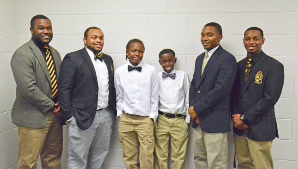 MESSENGER PHOTOS/ NGOC VO Above, (Center) Elijah Coleman and Mekhi McNair from CHMS met with mentoring Alpha Phi Alpha fraternity brothers (left to right) Herman Mitchell, Denzel Walker, David Turner and Jamal Banks. Below, Cole Oswald, Tyler Ward, Cody Paramore and Joshua Johnson, eighth-graders from CHMS dressed up for Chivalry Day.