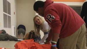 Joy Scarbrough and dozens of volunteers sorted and distributed thousands of t-shirts on Thursday as part of the Charles Henderson Athletic Foundation’s efforts to pay tribute to DeMario Harris Jr.  STAFF REPORTS