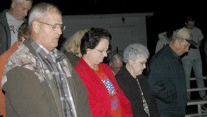 Gerald and Jean Murphy and Shirley and Lamar Steed pray before the Brush Arbor singing began.  MESSENGER PHOTO/JAINE TREADWELL