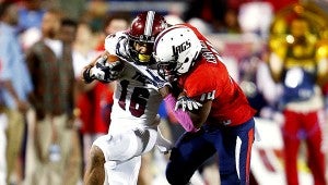 (Mike Kittrell/mkittrell@al.com) South Alabama cornerback Antonio Carter (14) tackles Troy wide receiver Chandler Worthy (16) in the first half Friday, Oct. 24, 2014, at Ladd-Peebles Stadium in Mobile, Ala.