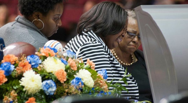 Messenger photo/Joey Meredith Mourners pause at the casket during a viewing prior to the funeral service for DeMario Harris Jr. on Saturday. 