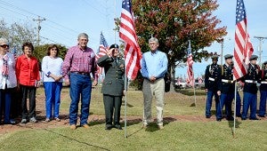 Paul Davis and brother Wayne Davis placed a flag at Bicentennial Park for Pugh Davis during Tuesday’s Veterans Day ceremony held by the City of Troy and American Legion Post 70.  MESSENGER PHOTO/SCOTTIE BROWN