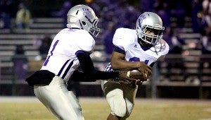 Pike County High School's Jerrell Lawson (1) passes off the ball to Tyrec Johnson (31) in the second round of high school play-offs on Friday, November 14, 2014 in Gordo, Ala.  SUBMITTED PHOTO