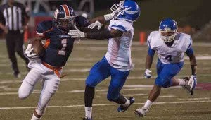CHHS running back Mondaris Dixon stiff-arms a Lanier defender in the Trojans’ home game on Oct. 3. 