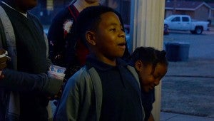 Jacobi Green sings along with others from the Christian Love Community Center on Seagers Street. The group went caroling through the neighborhood and left smiles wherever they went.  MESSENGER PHOTO/SCOTTIE BROWN