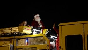 Santa smiles to the crowd as he brings up the rear for the Town of Goshen’s parade. Numerous people throughout the community came out to town hall to enjoy this year’s parade.  MESSENGER PHOTO/SCOTTIE BROWN