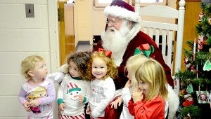 Santa visits with the children at Mother’s Day Out at First Baptist Church on Friday. Pictured from left to right are Madelynn Miller, Vincent Donofrio, Molli Kate Johnson, Anna Grace Daly and Hailey Jones.  MESSENGER PHOTO/COURTNEY PATTERSON