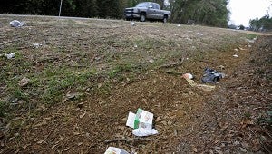 Cars pass litter on the side of Shellhorn Road. MESSENGER PHOTO/THOMAS GRANING