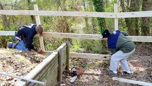 Ronnie Adams and Mark Alderman build a privacy fence in Adams’ backyard on Saturday.  MESSENGER PHOTO/COURTNEY PATTERSON