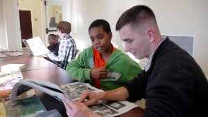 Phillip Johnson, a Troy University social science education major, and Ronje McCullough (right) spent time during the Read-in at the Troy Public Library reading newspaper sports articles